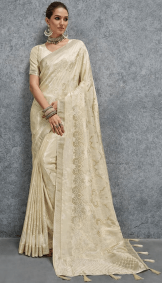 Elegant cream silk saree with woven jacquard floral motifs and rich border, paired with matching blouse, perfect for wedding, festive and party wear.