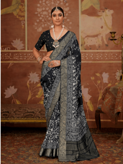 Woman wearing elegant black light weighted dola silk saree with intricate silver zari floral and traditional woven border, paired with matching blouse and statement silver jewelry in a heritage-themed setting.