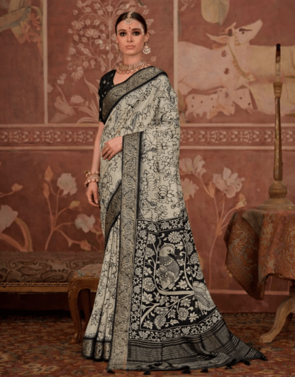 model wearing a black and ivory saree with intricate floral and peacock motifs, paired with a black blouse