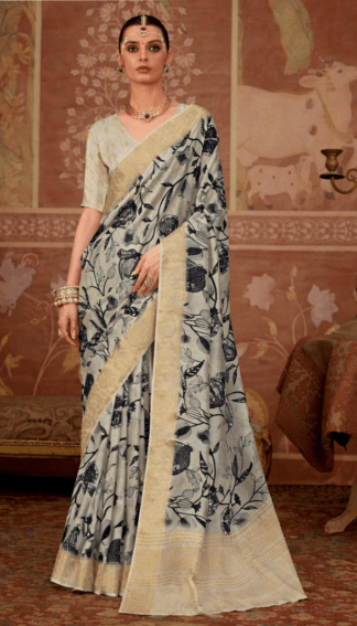 Model wearing an off-white floral printed silk saree with gold zari border, paired with matching blouse