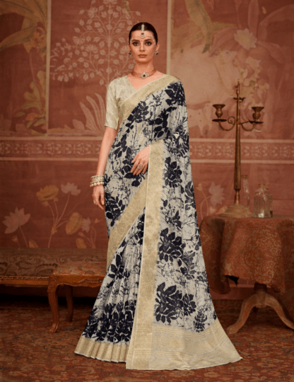 Model wearing an ivory silk saree with bold black floral prints and gold zari border.