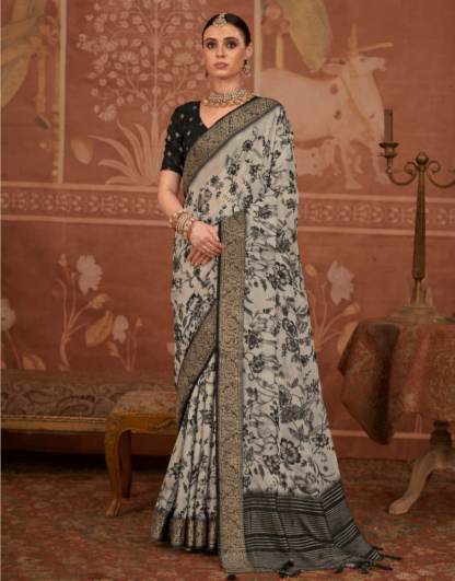 Model wearing a black and grey floral printed silk saree with intricate zari border, paired with a black blouse