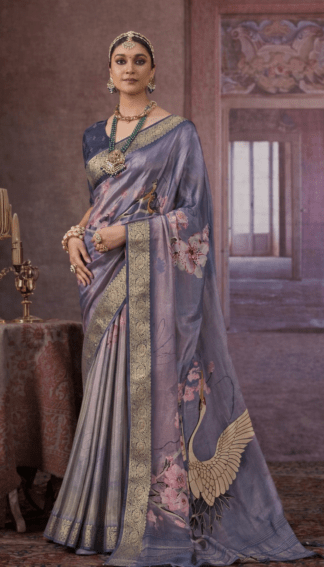 Steel grey silk saree with gold zari border, floral prints, and crane motif on the pallu.