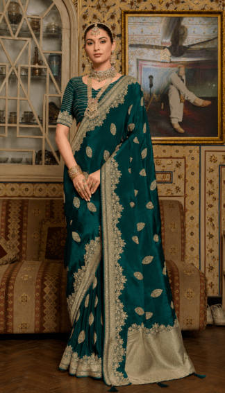 Bottle green silk saree with gold zari leaf embroidery and heavy scalloped border, paired with striped blouse