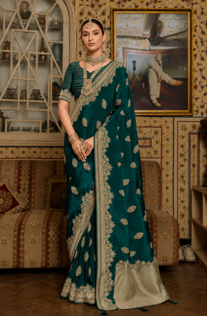 Bottle green silk saree with gold zari leaf embroidery and heavy scalloped border, paired with striped blouse