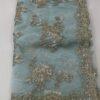 organza saree with gold zari and sequin floral embroidery and scalloped border, laid flat