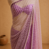 Full-length lavender pearl-embellished net saree draped on mannequin against a beige backdrop