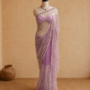 Full-length lavender pearl-embellished net saree draped on mannequin against a beige backdrop