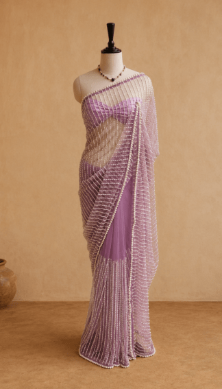 Full-length lavender pearl-embellished net saree draped on mannequin against a beige backdrop