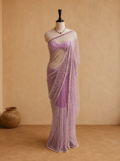 Full-length lavender pearl-embellished net saree draped on mannequin against a beige backdrop