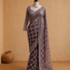 mauve embellished net saree draped on mannequin with flowing pallu