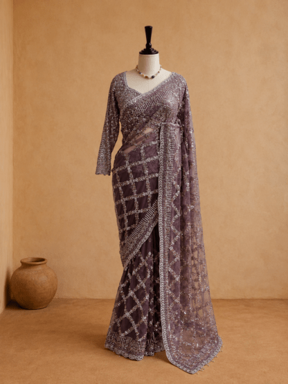 mauve embellished net saree draped on mannequin with flowing pallu