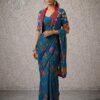 Woman wearing teal blue floral print saree