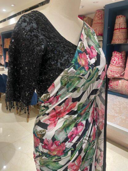 Close-up of lotus floral print saree pallu with black sequin blouse neckline embroidery