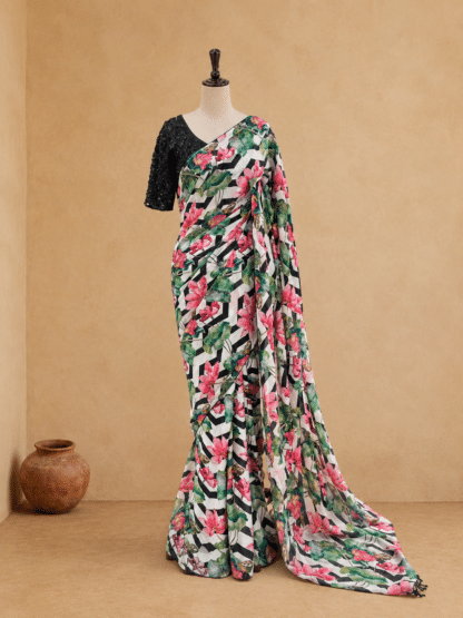 Full-length black and white lotus print designer saree draped on mannequin with tasseled sequin blouse