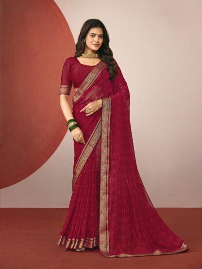 Woman wearing maroon chiffon saree with golden zari border and matching blouse