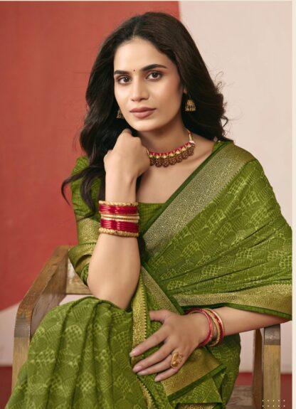 Woman wearing mehendi green chiffon saree with golden zari border and matching blouse