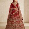 Full view of red bridal lehenga with heavy embroidery and matching scalloped net dupatta