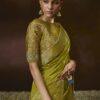 Woman wearing olive green zari woven silk saree with meenakari border and embroidered blouse