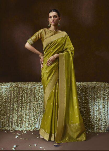 Woman wearing olive green zari woven silk saree with meenakari border and embroidered blouse