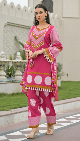 Woman wearing rani pink polka dot print cotton kurti palazzo set with mirror work neckline