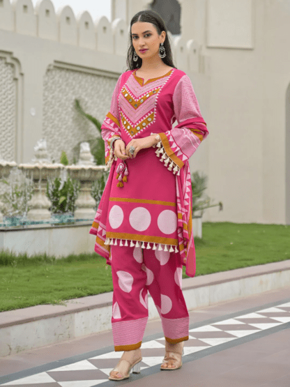 Woman wearing rani pink polka dot print cotton kurti palazzo set with mirror work neckline