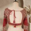 Close-up of red net saree with rose thread embroidery and designer sequin blouse