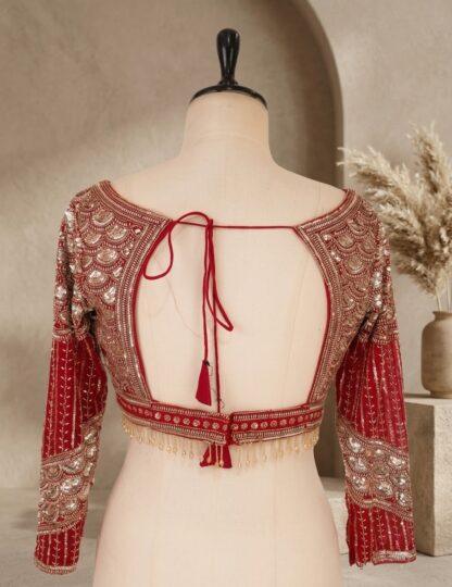 Close-up of red net saree with rose thread embroidery and designer sequin blouse