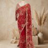 Red embroidered net saree with rose sequin work and scalloped border on mannequin