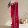 Rani pink saree with scalloped embroidered border and teal blue blouse displayed on a mannequin at Sagar Sarees