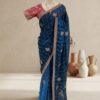blue saree with zigzag sequin work, embroidered border and contrast pink blouse displayed on a mannequin at Sagar Sarees